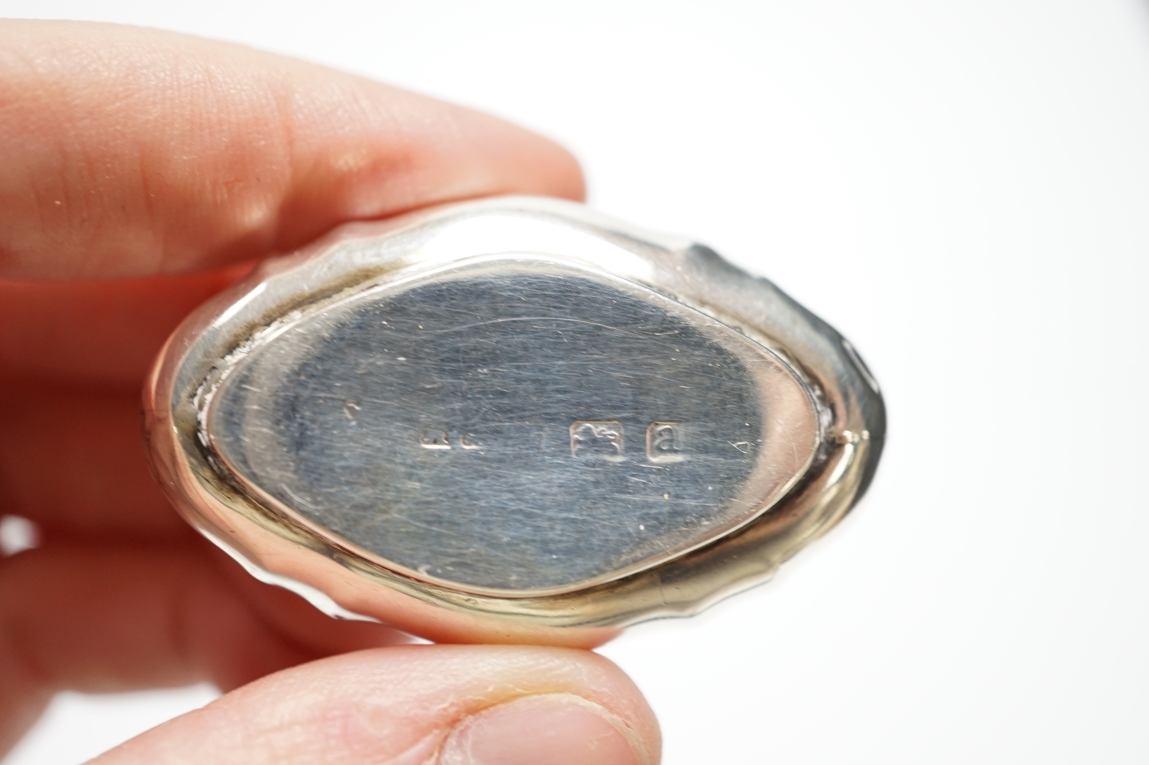 A late Victorian silver pill box with Reynold's Angel decorated cover, 47mm, a modern silver pill box and a Dutch white metal box.